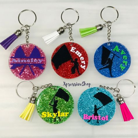 "A handmade personalized glitter Color Guard keychain just for you. Perfect for dance gift bags, majorettes, marching band gifts, backpacks, bag tags etc.  You can pick your choice of color for the glitter, name and flag. If no specification is given for the flag color in the personalization box, I will use black and white for the name if a color is not provided. If you would like the silhouette in a different color than black, please specify the color in the personalization box. Each key chain Gifts For Color Guard Cute Ideas, Color Guard Team Gifts, Colorguard Gifts Ideas, Color Guard Gifts, Majorette Dance, Marching Band Gift, Band Gifts, Color Guard Flags, Guard Gifts