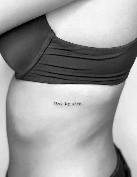 Writing On Ribs Tattoo Women, Tattoo Ideas On Ribs Quote, Stepping Into A New Me Tattoo, Text Tattoo Side Rib Women, Small Tattoos On Rib Cage, One Line Rib Tattoo, One Word Rib Tattoo, Rib Cage Script Tattoo, Dainty Rib Cage Tattoos