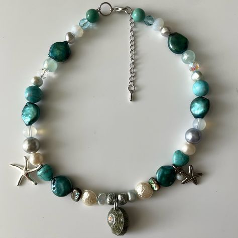 siren ˖°🌊𓇼⋆🦪₊ handmade shades of blue beaded necklace with a green turbo sea shell and starfish pendants made with freshwater pearls and various crystals! 13.5-16 inches long 🪼 #handmade #handmadejewelry #summer #mermaidaesthetic #beadednecklace #handmadenecklace Mermaid Aesthetic, Blue Beaded Necklace, Starfish Pendant, Upcycled Jewelry, Sea Shell, Starfish, Handmade Necklaces, Shades Of Blue, Fresh Water