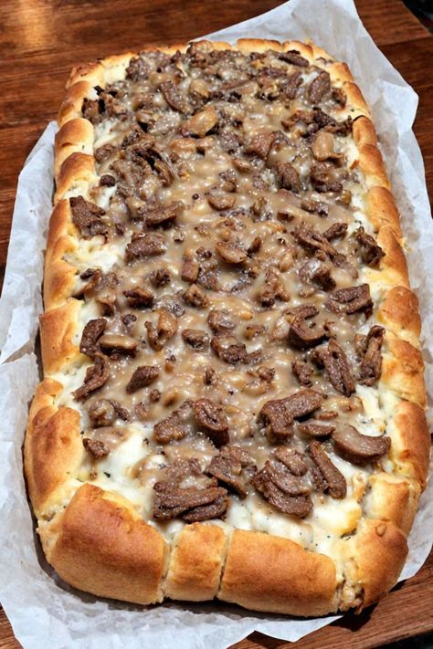 Philly Cheesesteak Cheesy Bread Recipe

Ingredients

- 1 loaf of Italian bread
- 1 cup cooked steak, thinly sliced
- 1/2 cup onion, finely chopped
- 1/2 cup green bell pepper, finely chopped
- 1 cup provolone cheese, shredded
- 1/2 cup cream cheese, softened
- 1 tablespoon olive oil
- 1/2 teaspoon garlic powder
- Salt and pepper to taste

Full Cooking Instructions on... Cheesy Bread Recipe, Cranberry Bread Recipes, Shredded Buffalo Chicken, Soup With Ground Beef, Cranberry Bread, Philly Cheese, Sliced Steak, Green Bell Pepper, Feta Pasta