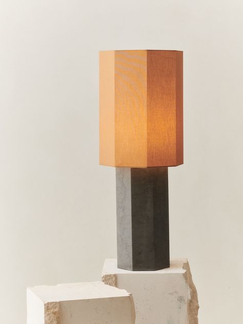 Put the finishing touches on a welcoming, organic living room design with a modern octagonal table lamp. It showcases a geometric gray marble base paired with a matching shade, creating a bold focal point for a contemporary living area or bedroom. The lamp is well-sized for a credenza, console, or stylish end table. Features: Octagonal silhouette adds geometric appeal in a modern accent table lamp Carved deep gray marble creates a rich, earthy ambiance Perfectly sized for a console, credenza, or bold end table Features a fine cotton lamp shade Designed by Louise Roe and manufactured in Europe Lamp Base: Grey Marble This product meets EU lighting standards and may require rewiring or an adapter for use outside of the EU. For more information, please contact sales@claudehome.com. Materials: Octagonal Table, Modern Accent Table, Hexagonal Table, Organic Living Room, Octagon Table, Modern Accent Tables, Ceramic Furniture, Louise Roe, Lampshade Designs