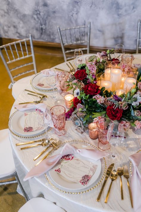 Gorgeous burgundy and pink centerpiece with touch of purple and gold. Wedding menus and gold flatware accents. #daytonwedding #cincinnatiwedding Burgundy Gold Pink Wedding, Pink And Maroon Wedding, Burgundy Blush And Gold Wedding, Burgundy Pink Wedding, Burgundy And Pink Wedding, Champagne Wedding Themes, Pink And Burgundy Wedding, Wine Colored Wedding, Pink Wedding Receptions