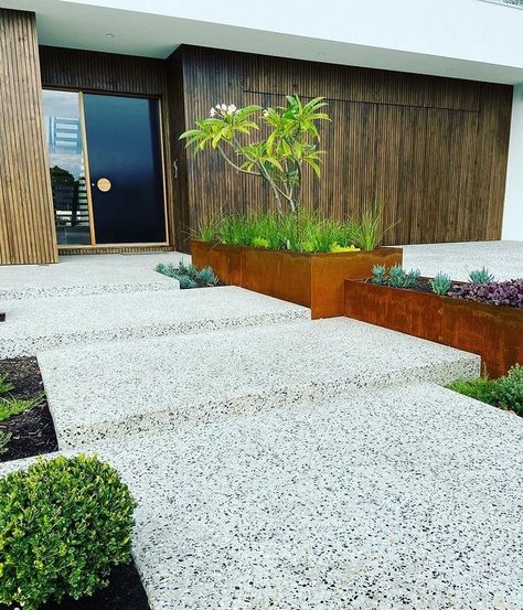 Outdoor Designer Store on Instagram: “Honed concrete steppers reveal the gorgeous aggregate that is flagged by weathered steal troughs and textural plants that soften the…” Garden Concrete Floor, Honed Concrete Driveway, Palm Springs Front Yard, Exposed Aggregate Patio, Concrete Driveway Ideas, Concrete Courtyard, Exterior Mood Board, Concrete Aggregate, Aggregate Patio