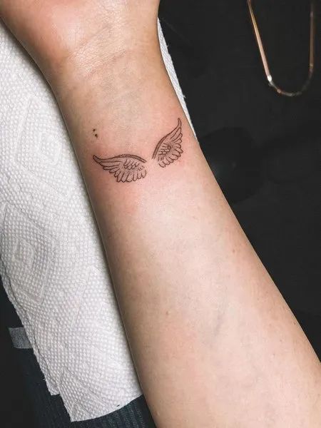 Angel Wings Tattoo On Wrist Wrist Angel Wing Tattoo, Wing Tattoo Wrist, Wings On Wrist Tattoo, Angel Wings Rib Tattoo, Angel Wings Tattoo On Wrist, Angel Wings On Wrist, Angel Wings Wrist Tattoo, Angel Wings Tattoo Placement, Angel Wings Tattoo Ideas