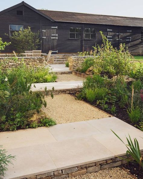 Artisan Landscapes ® on Instagram: "The stepped walkway leading up to the new terrace and old stables. Purbeck walling, limestone paving and Cotswold gravel combine to create a gentle level change, softened by the bordering plants." Limestone Gravel, Old Stables, Limestone Paving, Gravel Landscaping, Paving Ideas, Garden Levels, Gravel Garden, Farmhouse Garden, Traditional Farmhouse