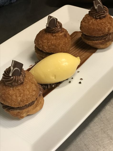 Profiteroles filled with chocolate cremeux served with passion fruit sorbet Profiteroles Presentation, Profiteroles Plating, Passion Fruit Sorbet, Profiterole, Fruit Sorbet, Plate Presentation, Food Tech, Food Gallery, All About