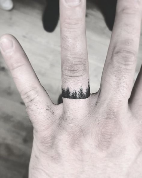 A Forest #weddingband #ringfingertattoo #weddingringtattoo Forest Wedding Ring Tattoo, Tree Wedding Ring Tattoo, Forest Ring Tattoo, Mountain Wedding Ring Tattoo, Watercolor Finger Tattoo, Tiny Forest Tattoo, Forest And Ocean Tattoo, Mountain Music Tattoo, Finger Tree Tattoo