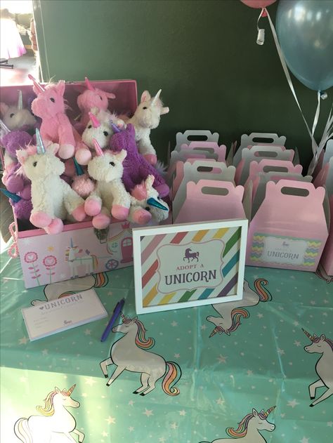 Unicorn party  Plush unicorns in a chest  from Burlington coat factory, table boxes from Amazon, adoption certificates box stickers and digital sign file from homespun hostess on Etsy white frame from wal mart, and target tablecloth Adopt A Unicorn, Rainbow Unicorn Birthday Party, Unicorn Birthday Party Decorations, Burlington Coat Factory, Rainbow Unicorn Party, Unicorn Themed Birthday Party, Digital Sign, Rainbow Unicorn Birthday, Wal Mart