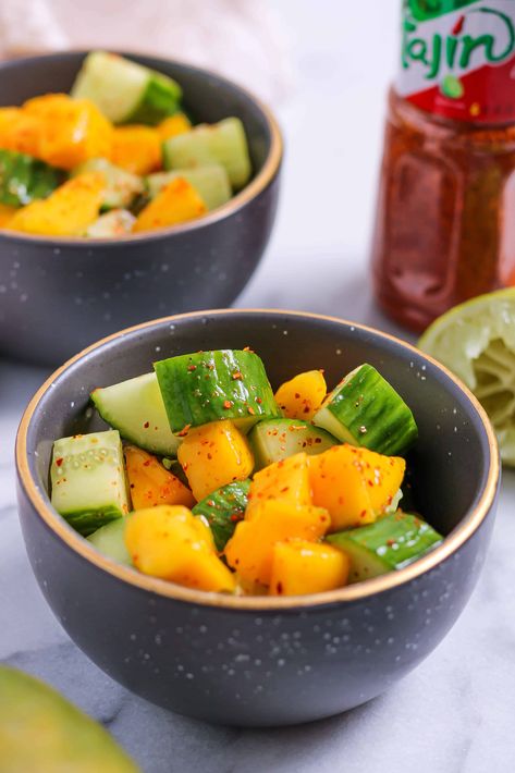 This Mango Cucumber Salad is simple but packed with sweet, bright, subtle chile, citrusy flavor. It makes an easy, refreshing side or snack. Mango And Tajin Snack, Mango Cucumber Salad, Freezing Pesto, Light Side Dishes, Simple Healthy Recipes, Mini Cucumbers, Mango Recipes, Yummy Salad Recipes, Pickling Cucumbers