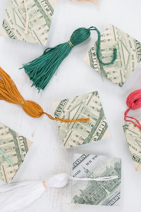 Once spring hits, we start thinking up unique graduate gifts that involve money! One year, we added money to balloons and now we’ve made the most charming origami money graduation caps and tassels to go with them! These little money grad caps are much more exciting than just plopping cash in a card! To make the hats, there are some really great … Graduation Cash Gift Ideas, Unique Graduation Party Ideas, Ways To Give Money, Money Folding, Graduation Cap Tassel, Origami Money, Graduation Money Gifts, Diy Graduation Gifts, Folding Money