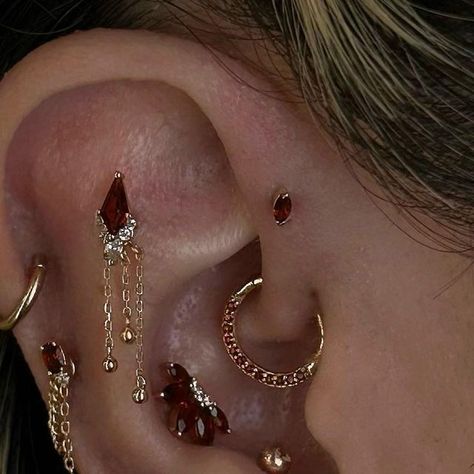 Nathans Tattoos and Piercings on Instagram: "Stunning curation by @sashapokey using @buddhajewelryofficial garnet pieces✨  #buddhaearstyle #earcuration #curation #buddhajewelry #buddhajewelryofficial #ultimateear #ultimatecuration #epicearcuration #piercedbtnathan #upgradedbynathan #nathans #nathanstattoosandpiercings  #losangelestattoo #losangelespiercing #losangelespiercer" Ears With A Lot Of Piercings, Ear Style Ideas, Eat Curation Ideas, Stacked Jewelry Earrings, Piercings With Gauges, Eat Curation, Pretty Ear Piercings Unique, Ear Jewelry Aesthetic, Black And Gold Ear Piercings