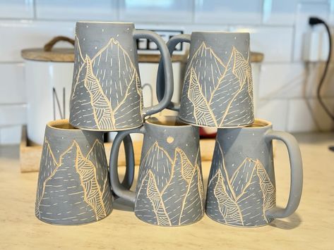 12 mountain mugs carved up and drying out. I love these! I normally do a dark blue for the interior, any other suggestions? #sgraffitto #pottery #ceramic #mountains Mountain Mugs, Ceramics Ideas, Clay Ceramics, Handmade Pottery, Dark Blue, Carving, I Love, Ceramics, On Instagram