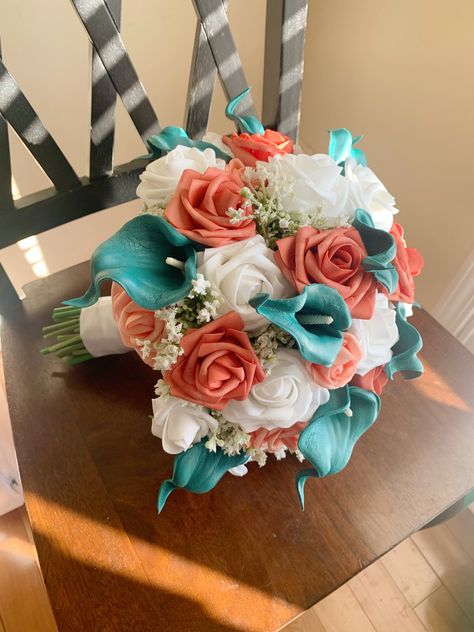 "Check out our current coupons here: https://www.touchofamorfloral.com/general-5 11\"-12\" Bridal Bouquet 8\"-9\" Bridesmaid Bouquet 6\"-7\" Jr. Bridesmaid Bouquet/Toss Boutonniere - Calla Lily and Miniature Coral Rose Bouquets are handmade for your special occasion. High-quality silk teal roses with a choice of white or ivory soft-touch foam roses and realistic faux greenery are used to give your bouquet a vivid, natural look that will never wilt! For special requests or color/size variations, please message me, and I would love to work with you to make your dream bouquet for your special event or home decor. Custom orders and bouquet re-creation orders are also available upon request. If you would like an artificial flower replica of a special bouquet from your past or please message me Teal And Coral Flower Arrangements, Coral Teal Wedding, Aqua And Coral Wedding, Coral And Turquoise Wedding Colors, Teal And Peach Wedding, Turquoise And Coral Wedding, Coral And Teal Wedding, Beach Bridal Bouquet, Teal Centerpieces