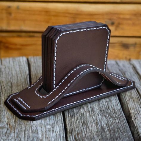 When it comes to home decor and functionality, leather coasters are a game-changer. This set of 6 coasters, complete with a holder, not only serves a practical purpose by protecting your surfaces from pesky drink rings but also adds a touch of sophistication to your coffee or tea time. The variety of colors available - light brown, dark brown, and black - ensures that you can choose the perfect set to complement your home's aesthetic or match your personal style.  What sets these coasters apart Leather Coaster Ideas, Leather Coaster Holder, Leather Coaster, Leather Playing Card Case, Luxury Brown Leather Card Holder, Leather Coaster Set, Minimalist Leather Wallet, Drinking Accessories, Leather Coasters