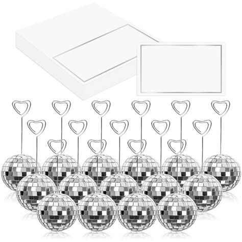 PRICES MAY VARY. Package Includes - You will receive 20pcs of disco ball card holders, 20pcs of heart swirl wires and 20pcs of tented cards, complete and value set to meet your various needs. Dazzling Silver Look - Bling silver disco ball bases with heart swirl wire, and place cards with silver foil frame, our place cards and holders set are delicate and glamourous, which can light your guests eyes up and leave them deep impressions. Good Quality - The disco ball stands that made of foam and dec Disco Ball Table, Disco Ball Wedding Decor, Wedding December, Disco Birthday, Disco Birthday Party, Couples Bridal Shower, Disco Theme, Table Number Holders, Ball Wedding