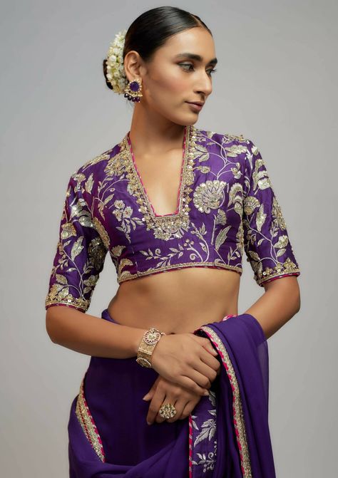 A classic chiffon sari with delicate gold embroidery gracefully lifts the patterns, adding grace. Paired with a beautiful brocade and zardosi blouse, exudes opulence and grandeur reminiscent of royalty. Luxury Purple Dola Silk Traditional Wear, Luxury Purple Embroidered Blouse Piece, Festive Brocade Pre-draped Saree With Zari Work, Elegant Brocade Pre-draped Saree For Designer Wear, Traditional Georgette Blouse For Eid, Purple Georgette Blouse With Intricate Embroidery, Gold Anarkali Georgette Blouse, Elegant Kundan Blouse For Wedding, Gold Blouse With Resham Embroidery In Georgette