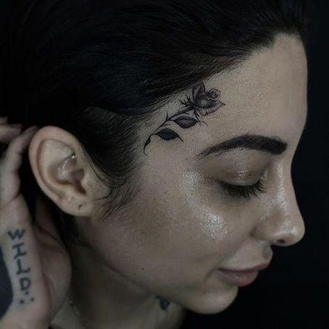 10 Tasteful Face Tattoos For Women & Their Meanings Tattoo Above Eyebrow, Hawaiian Tattoo Meanings, Girl Flower Tattoos, Small Face Tattoos, Delicate Face, Face Tats, Face Tattoos For Women, Girl Face Tattoo, Small Rose Tattoo