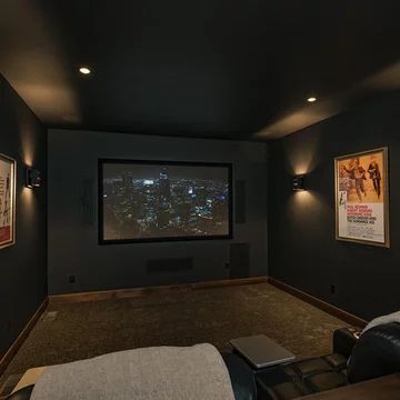 Media Room Curtains Home Theaters, Black Wall Movie Room, All Black Media Room, Movie Theater Paint Colors, Home Theatre Painting Ideas, Home Theater Accent Wall, Theatre Living Room Ideas, Navy Blue Theater Room, Black Home Theater Room