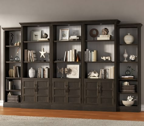 Parker House Shoreham PKH-SHO435-MDR-HOF-S1, This 24 inch wide bookcase provides the perfect blend of style and functionality. The gorgeous medium roast brown finish over birch veneers is contrasted by a effortless white finish and accented with burnished nickel hardware, creating a unique and eye-catching piece that is sure to elevate any room. The back panels can be reversed for two distinct looks, and the removable side crown moldings allow bookcases to be bunched together for a more customiz Top Of Bookcase Decor, Office With Built In Bookshelves, Modern Library Room, Office Shelving Ideas, Moody Den, Bookcase Ideas, Wide Bookcase, Office Built Ins, Black Bookcase