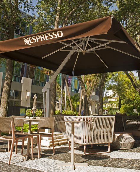 Indulge in a boutique cup of coffee with today's #featurefriday at Nespresso. Sip a Latte Macchiato and enjoy a good casual atmosphere indoors or outdoors under some Poggesi shade. Want to design a custom umbrella for your business? Design your own here: https://www.poggesiusa.com/custom-umbrellas/?utm_campaign=coschedule&utm_source=pinterest&utm_medium=Poggesi%20USA&utm_content=Custom%20Outdoor%20Umbrellas%20-%20Design%20Your%20Own%20-%20Poggesi%C2%AE%20USA Outdoor Bar With Umbrella, Cafe Canopy Design Outdoor, Umbrella Outdoor Cafe, Wagasa Umbrella, Custom Umbrella, Commercial Umbrellas, Offset Patio Umbrella, Cantilever Patio Umbrella, Outside Seating