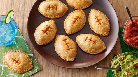 These football-shaped chicken empanadas are as easy to eat as they are to make! Fill Pillsbury™ Pie Crust with a creamy green chile-chicken mixture, shape into footballs and bake. Serve with guacamole and salsa for the ultimate game day app. Football Empanadas, Cheese Empanadas, Chicken Empanadas, Appetizers Table, Green Enchilada Sauce, Game Day Appetizers, Delicious Appetizer Recipes, Cream Cheese Chicken, Empanadas Recipe