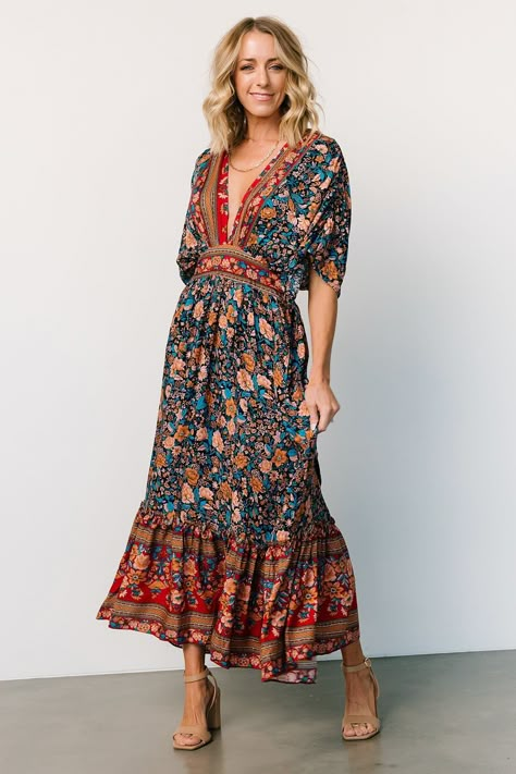 Baltic Born exclusive style Navy with rust, peach, teal, and red accents Boho border floral print throughout Easy-to-wear, lightweight material Surplice neckline Gathered detailing at bodice Short, flowy sleeves with ruching Keyhole closure at back neck High waistline with smocking at back Functional side pockets Flowing midi-length skirt 100% Rayon Sierra is 5’8, cup size 37”, size 6/8 and wearing size L Trina is 5'6, cup size 32D, size 2 and is wearing size S Hipster Outfits For Women, Boho Border, Baltic Born, Velvet Maxi Dress, Hipster Outfits, Flowy Sleeves, Surplice Neckline, Dress Dusty, Navy Midi Dress