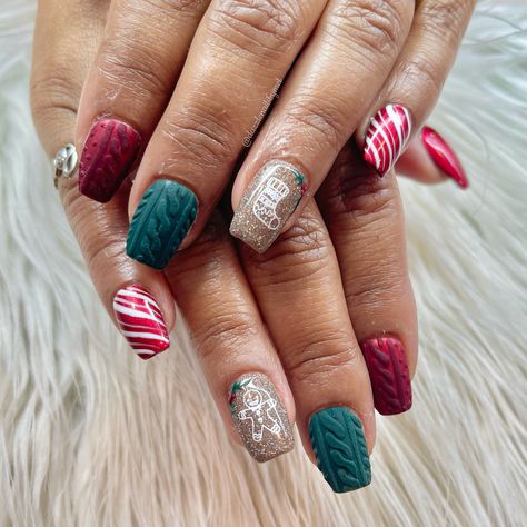 Super cute Christmas nails with red and green sweater nail, candy cane stripes with beautiful glitter with gingerbread and stocking stamp! With a added little holly Green Sweater Nails Christmas, Red And Green Sweater Nails, Chocolate Christmas Nails, Christmas Sweater Nail Designs, Ugly Sweater Nails, Green Sweater Nails, Sweater Christmas Nails, Christmas Sweater Nails, Candy Cane Nails