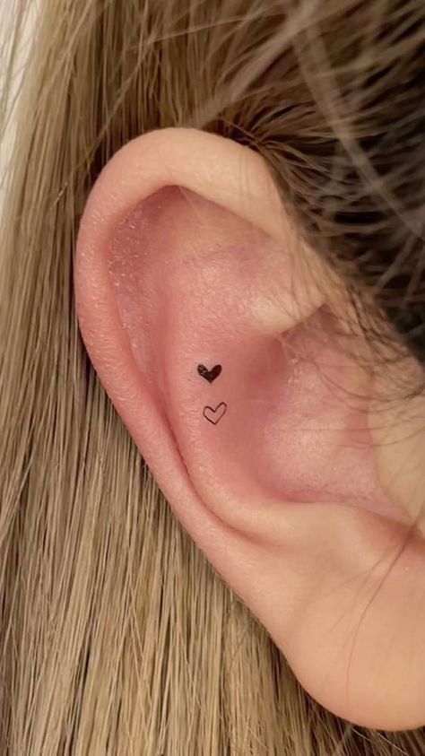 Tiny hearts tattoo located on the ear, minimalistic Heartbeat Tattoo Behind Ear, Tiny Heart Tattoo Behind Ear, Heart In Ear Tattoo, Heart On Ear Tattoo, Small Inner Ear Tattoos For Women, Small Tragus Tattoo, Tragus Tattoo Ideas, Ear Tattoo Inner Heart, Micro Ear Tattoo