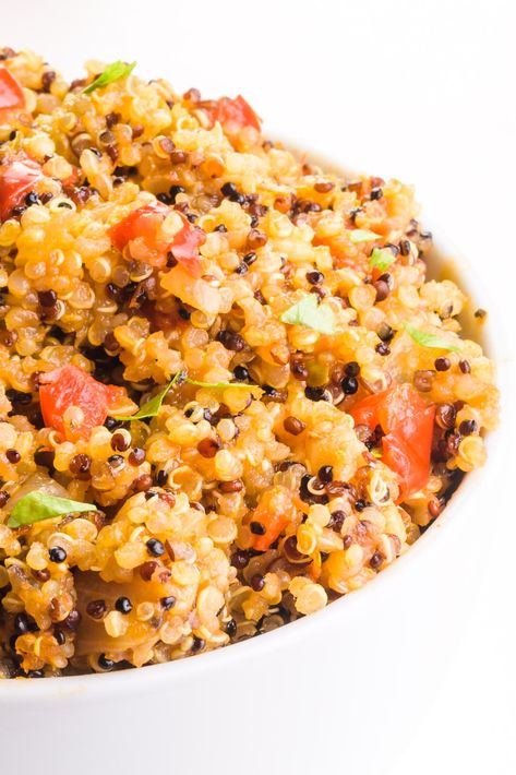 This healthy Spanish Quinoa Recipe makes a perfect side dish for your favorite plant-based Mexican dinners! Spanish-style quinoa is EASY to make and it's also gluten-free and very nutritious! Serve this in stuffed peppers — topped with vegan cheese of course! It's also a great side dish for vegan tacos, burritos, and more! #vegan #namelymarly #quinoa #spanishrice #spanishquinoa #healthyquinoa Spanish Quinoa, Spanish Quinoa Recipes, Quinoa Spanish Rice, Spanish Style Quinoa, Mediterranean Quinoa Dish, Mexican Style Quinoa, Vegan Quinoa Stuffed Peppers, Vegetarian Quinoa Recipes, Quinoa Stuffed Bell Peppers Vegan