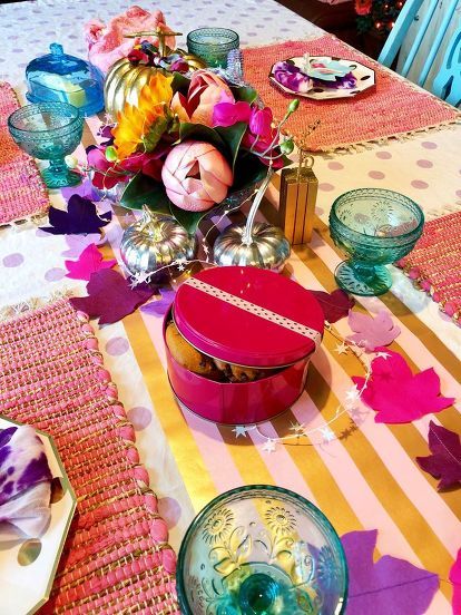 With things I already had around the house, I was able to put this diy whimsical Thanksgiving table together! I had these cool paper plates in my "party stash" and I cut these leaves out of felt. I printed the names out for place settings. I pulled out my pink placemats and used wrapping paper for the table runner. Gathered my metallic pumpkins and tie dye napkins. I filled my purple cornucopia with bright colored flowers. I used a colorful pink tin for cookies, pretty fab… Whimsical Thanksgiving, Metallic Pumpkins, Colorful Thanksgiving, Bright Colored Flowers, Pink Placemats, Thanksgiving Paper, Fall Leaf Garland, Metal Pumpkins, Blue Dishes