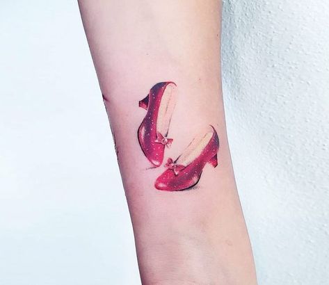 Dorothy Shoes tattoo by Ilaria Tattoo Art Dorothy Red Shoes, Shoes Tattoo, Oz Tattoo, Dorothy Shoes, Feminist Tattoo, Shoe Tattoos, Ruby Red Slippers, Cool Wrist Tattoos, Mommy Tattoos