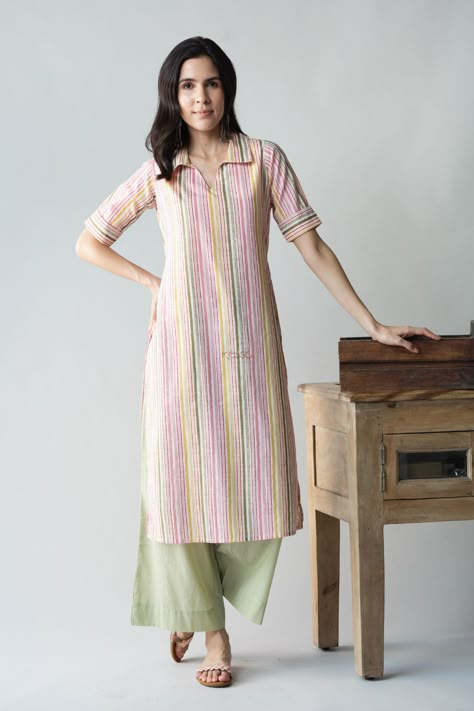 Tailored out of 100% premium cotton, Sabrang is a graceful play of colors to brighten your everyday outfit. The vertical lines of color are sure to add a few inches to your height visually. The collared neckline and elbow sleeves add to the chic beauty of Sabrang. Balance out the colorful playfulness with our neutral pistachio green palazzo. Straight Kurti Designs Cotton, Shirt Collar Kurti Design, Kurta Designs Women Casual, Fashionable Saree, Stitch Dress, Kurta Women, Stylish Kurtis Design, Tie Dye Tops, Simple Kurta Designs