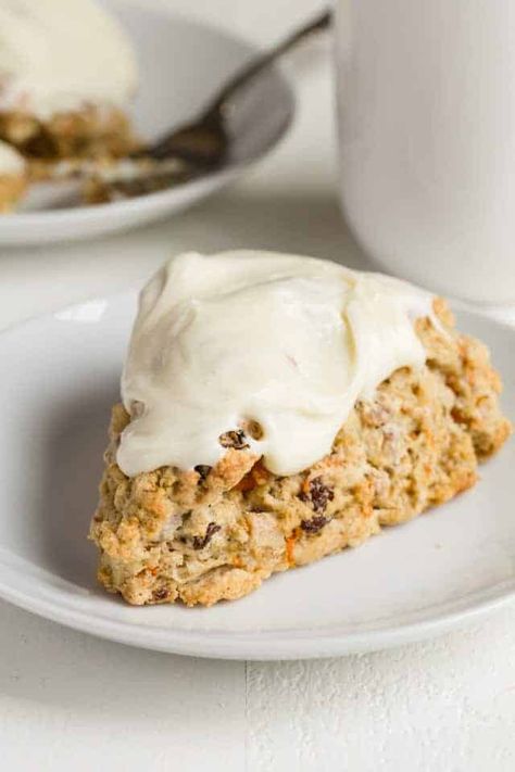 Carrot Cake Scones are a fun spin on Easter's classic carrot cake. Shredded carrots, raisins, walnuts and cozy spices speckle the inside of these soft scones for the ultimate comfort breakfast! #bakedbyanintrovertrecipes #scones #carrotcake #easter Soft Scones, Carrot Cake Scones, Classic Carrot Cake, Scones Recipe Easy, Shredded Carrots, Carrot Recipes, Scone Recipe, Savoury Cake, Food Cakes