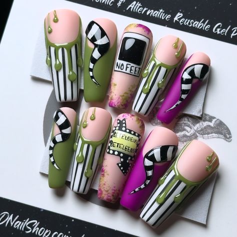 It’s showtime for these Beetlejuice nails! Beetlejuice, Beetlejuice, Beetle—whoops, almost said it three times! 😂💚💜 Pictured on Après Long Coffin 💅🏻 ⁣ .⁣ .⁣ .⁣ .⁣ .⁣ #sandworm #beetlejuiceedit #spooky #betelgeuse #beetlejuicecostume #ghostwiththemost #beetlejuice #letsturnonthejuiceandseewhatshakesloose #artist #3dnails #beetlejuicebeetlejuicebeetlejuice #halloween365 #nailsofinstagram #beetlejuicenails #timburtonstyle #glowinthedarknails #timburtonfan #halloweennails #halloweenlifestyle #go... Bettel Juice Nail, Beetlejuice French Tip Nails, Beetlejuice Halloween Nails, Betelgeuse Nails, Beetle Juice Nail Art, Bettle Juice Nail, Short Beetlejuice Nails, Bettle Juice Nail Ideas, Beetlejuice Nails Short