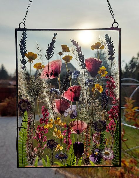 The flower stained glass are made by me in my home. I collect all the flowers and greenery, dry them, iron them and frame them. Every stained glass is unique because flowers in nature are different and are never the same. I use plants that will retain their color for a long time. You must know that they may change color after some time, this is because I don't dye them. EXECUTION: I place flowers between two transparent glass panels. They are connected with copper foil and soldered with tin. Fra Pressed Flower Suncatcher, Pressed Botanical Art, Stained Glass Frames, Flower Suncatcher, Botanical Home, Pressed Botanicals, Pressed Flower Crafts, Large Decor, Pressed Flower Art