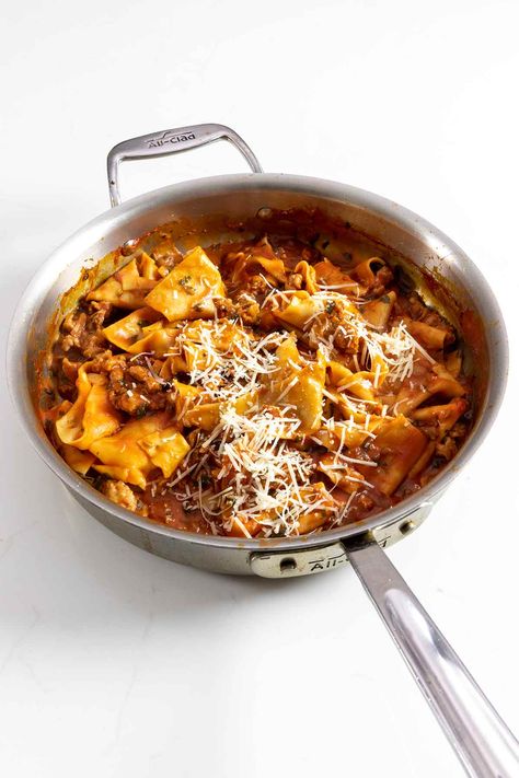 This easy one-pot pasta meal from Jamie Oliver features fresh pasta and sausage smothered in a luxurious tomato sauce. Our testers are calling it a quick, elegant, comforting meal. Jamie Oliver One Pot Recipes, One Pot Spicy Sausage Pasta, Jamie Oliver Sausage Pasta, Sausage Puttanesca, Sausage Pappardelle, Jamie Oliver Cabbage Pasta, Phillips Pasta Maker, Pappardelle Recipe, Pasta Sausage