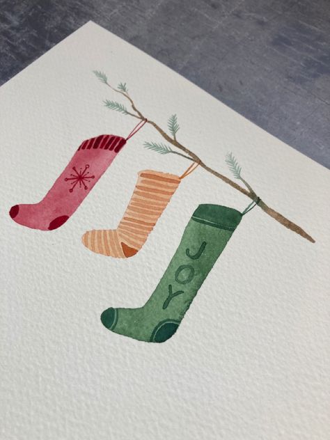 Learn to paint these lovely watercolour Christmas eve stockings. Perfect for beginners, learn to paint with Harriet de Winton on the de Winton Paper co. Youtube channel by clicking the link! #christmasstocking #christmasstockingtutorial #youtubewatercolour #watercolor #christmaswatercolourideas #christmascraftsforkids #christmascraftideas #christmaswatercolor Watercolour Christmas Stocking, Cute Watercolour Christmas Card, Watercolor Stocking Christmas, Stocking Drawing Christmas, Christmas Painting Inspiration, Cute Watercolour Christmas Cards, Beginner Christmas Watercolor, Christmas Stockings Watercolor, Christmas Watercolor Beginner