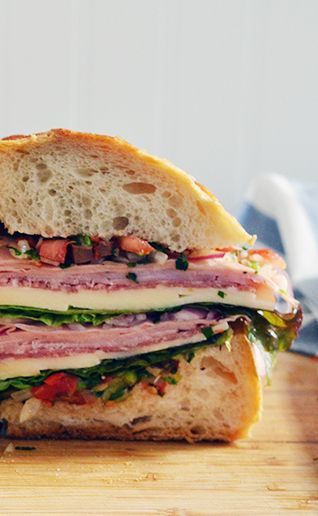 ► Muffuletta Sandwich Recipe: Italian or French bread loaves, soppresata, mortadella, provolone, ham, red leaf lettuce, red onion, white vinegar, sugar, tomatoes, yellow onion, mixed sliced olives, celery, hot peppers (jalapenos), flat leaf parsley, marinated sweet cherry peppers, olive oil, red wine vinegar, garlic, oregano, fresh basil, salt and pepper. Super Bowl Sandwiches, Muffuletta Recipe, Muffaletta Sandwich, Muffuletta Sandwich, Food Italian, Italian Sandwich, Party Sandwiches, Tomato Relish, Sub Sandwiches