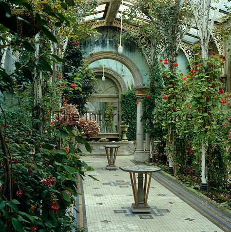 This Victorian conservatory has an original period tiled floor interspersed at intervals with mosaic-topped pedestal tables Victorian Greenhouse Interiors, Victorian Winter Garden, Beautiful Greenhouse Interior, Conservatory Flooring Ideas, Victorian Solarium, Victorian Garden Aesthetic, Victorian Greenhouse Conservatory, Whimsical Greenhouse, Victorian Conservatory