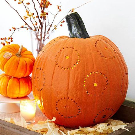 Add a little graphic gusto to your home with a pumpkin that’s drilled. Use a template to map out perfect circles for drilling, or draw the design freehand for a folk art effect. Drill small holes along the pattern lines. Use care; too much pressure may break the pumpkin shell. These no-fuss pumpkin carving ideas will have your house looking festive in no time! Pumpkin Carving With Drill, Pumpkin Creations, Free Pumpkin Carving Stencils, Funny Pumpkin Carvings, Pumpkin Carving Stencils Free, Care Too Much, Pumpkin Carving Stencils, Pumpkin Carver, Pumkin Carving