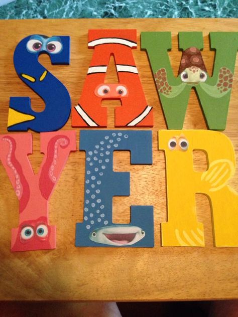 My grandsons birthday is Dory/Nemo theme and my daughter asked me to make the letters of his name (Sawyer) into the characters from the movies.  The letters are wooden and came from Hobby Lobby, then i printed the characters eyes from the internet and painted the rest to make it look like them. Finding Nemo Birthday Cake, Nemo Baby Shower, Finding Nemo Baby, Dory Birthday Party, Finding Nemo Party, Finding Dory Birthday, Nemo Birthday Party, Dory Birthday, Finding Nemo Birthday