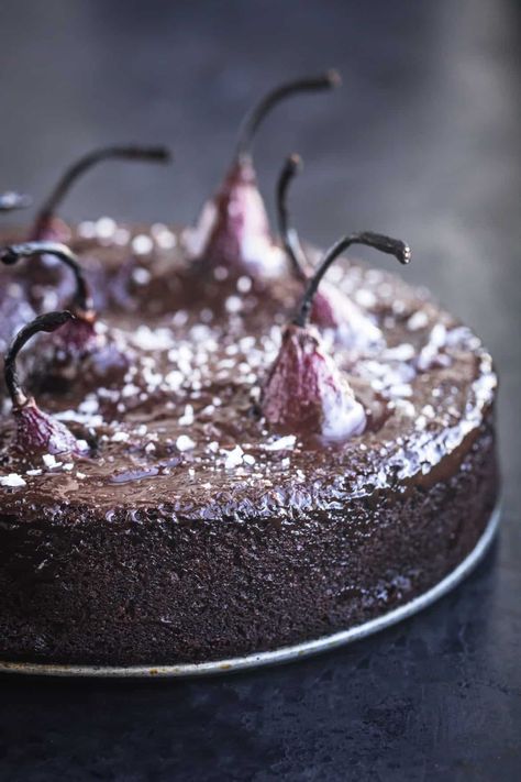 Deliciously impressive and easy to make red wine spiced poached pear and chocolate cake! Stunning deep ruby whole pears popping out of a moist boozy chocolate cake…fall baking at it’s very best! | Waves in the Kitchen | #spicedredwine #chocolatecake #holidaybaking #poachedpears #pearcake Pear And Chocolate Cake, Pear And Chocolate, Cake Fall, Wine Poached Pears, Boozy Chocolate, Winter Baking, Pear Cake, Fall Dessert Recipes, Chocolate Cinnamon