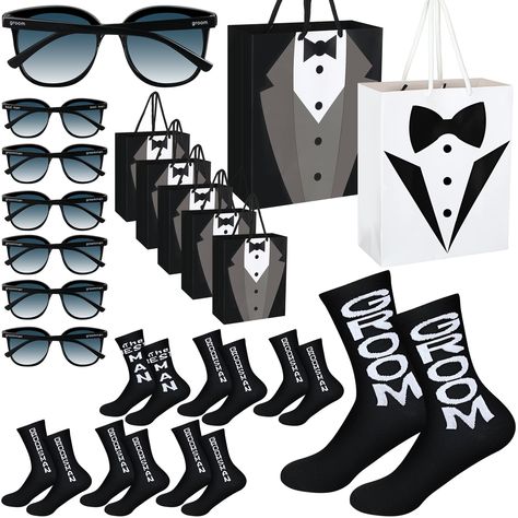 PRICES MAY VARY. Cotton Gentleman Groomsmen Gift Set: you will receive 7 sets of groomsmen gifts, including 7 pieces of gift bags (1 white groom gift bag and 6 black groomsmen bags), 7 pairs of socks and 7 pairs of sunglasses, stylish and interesting, this ample quantity can certainly meet your wedding or proposal party decorative needs Reliable Material and Proper Size: our groomsmen bridesmaid wedding gift bag are made of quality paperboard material, approx 23 x 19 x 9 cm/ 9.1 x 7.5 x 3.5 inch Grooms Men Gifts Ideas, Diy Groomsmen Proposal, Sunglasses For Wedding, Groom Sunglasses, Groomsmen Bags, Black Groomsmen, Groomsmen Sunglasses, Asking Groomsmen, Groomsmen Gift Ideas