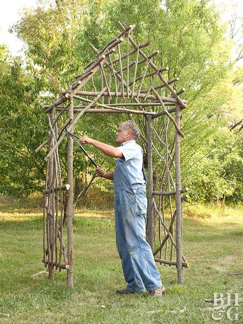 For added support, drive four 3-foot-long metal stakes into the ground next to the legs of the arbor. Attach the legs to these stakes with utility wire. Tip: Extend the life of the arbor by spraying it with a mixture of 2 parts linseed oil and 1 part turpentine. Use a pump sprayer and clean the tip when finished. Serre Diy, Diy Arbour, Twig Furniture, Arbors Trellis, Building A Pergola, Garden Arbor, Diy Greenhouse, Branch Decor, Inspire Me Home Decor