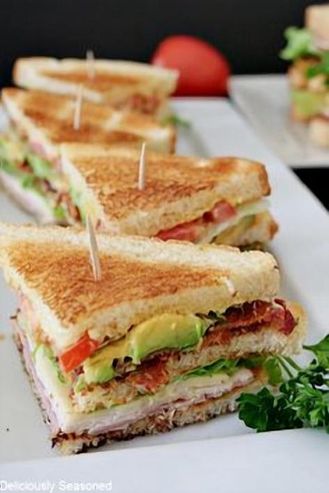 Elevate your lunch game with this easy-to-make club sandwich recipe that's perfect for any occasion. Layered with crispy bacon, juicy turkey, fresh lettuce, and ripe tomatoes, this sandwich is a classic favorite that never disappoints. Whether you're packing it for a picnic or enjoying it at home, this club sandwich promises a burst of flavor in every bite. Follow our step-by-step guide to create a mouthwatering meal that's sure to impress family and friends alike. Club Sandwich Recipe, Turkey Club Sandwich, Club Sandwich Recipes, Juicy Turkey, Mcdonalds Breakfast, Turkey Club, Classic Sandwich, Club Sandwich, Snack Items