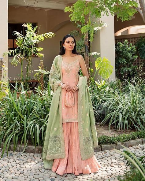 Click to view the outfit details. The fitted kurti of Mahi gorgeously pairs with a voluminous crushed sharara and a contrasting mint green dupatta. Delicate threadwork along with sheesha and sequins add the perfect bling to this sophisticated look. #FaizaSaqlain #Saanjh #Luxuryfestive #Newcollection Fitted Kurti, Crushed Sharara, Green Kurti, Faiza Saqlain, Green Sharara, Wedding Lenghas, Mint Outfit, Ethenic Wear, Green Dupatta