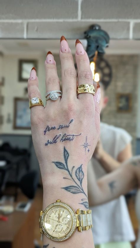 Hand Words Tattoo, Number On Finger Tattoo, Divine Hand Tattoo, Celebrity Hand Tattoos, Dove Tattoo Hand, Hand Tattoos Script, Girly Hand Tattoos Ideas, Quote Hand Tattoo, Large Hand Tattoo