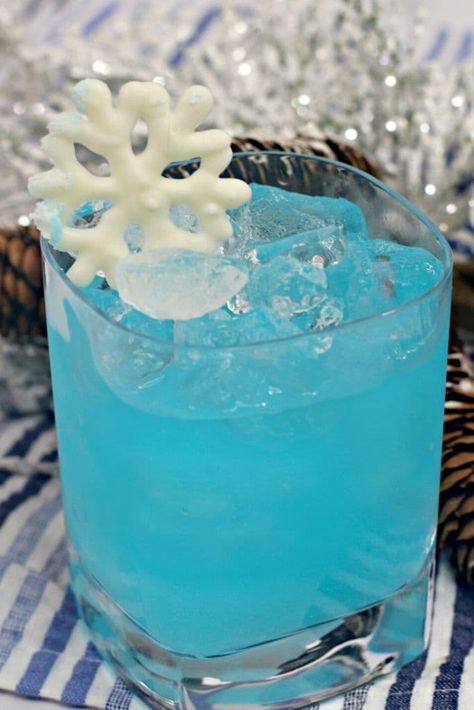 Enjoy Elsa's Frozen Cocktail while your kids are busy watching Frozen. Or serve it to the adults for a Frozen 2 watch party. It's yummy - think of it like an electric long island iced tea. Gorgeous, blue and cold. #frozen #Elsa #bluecuracao #electriccocktail #lit Elsa Cocktail, Blue Curacao Recipe, Curacao Drink, Blue Curacao Drinks, Disney Inspired Food, Ice Party, Light Drinks, Frozen Cocktail, Winter Drink