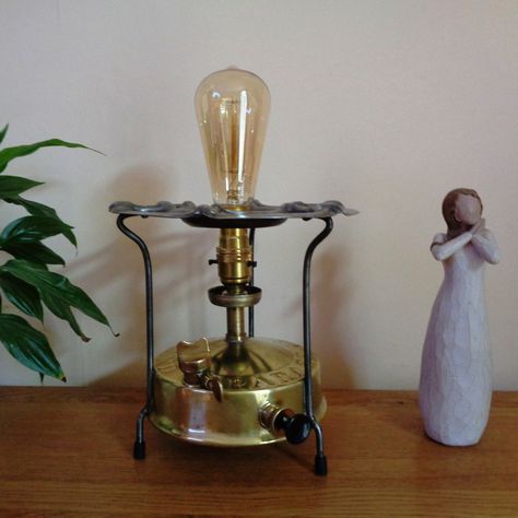 A fully converted primus camping stove with an LED antique-style bulb. The light from reflected off the brass base will warm any room. #thetoolrecycler #vintagetools #repurposed #mancave #workshop #garage #homeoffice #Industrialstyle #rusticstyle #steampunkstyle #recycled #unusualgift #studio #campingstovelight #primusstovelamp Primus Stove, Workshop Garage, Vintage Camping, Camping Stove, Vintage Tools, Metal Ring, Unusual Gifts, Absinthe Fountain, Antique Style