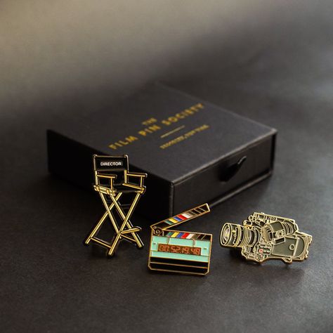 The Director's Box Set is perfect for well...any kind of director! Pin Details: Director's Chair: 2" Black nickel metal with two locking backs Cinema Camera: 1.75" Gold metal with two locking backs Timecode Slate: 1.4" Gold metal with two locking backs. *GLOWS IN THE DARK* Orders shipped outside the U.S. are subject to import taxes (VAT) payable by the customer at time of delivery. Film Pin Society is not not responsible for these duties. Director Gifts, Cinema Gift, Cinema Box, Actor Gifts, Pr Kit, Director's Chair, Film Gift, Pin Box, Movies Box